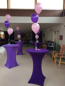 Three latex balloons on a foil weight.