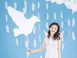Little girl holding dove shaped balloon.