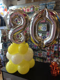 Silver number 80 balloon on top of white and yellow balloons.