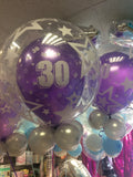 Purple 30th balloon inside another clear balloon.