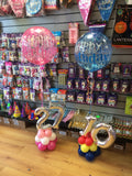 Number shaped balloon designs in different colours with large happy birthday balloon on top.