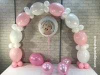 Pink and white balloon arch and photo balloon.