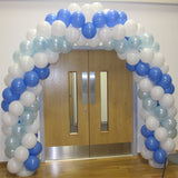 Large blue and white balloon arch over doorway.