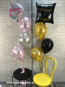 Three latex balloons with a printed foil balloon on top.