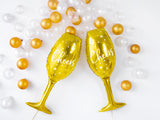 Two gold champagne bottle shaped balloons.