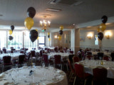 Set of three balloons on a table for a special event.