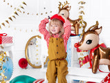 Child with cute Christmas reindeer foil balloons.