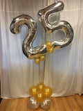 Large 25 shaped balloon design in silver and gold standing on floor.