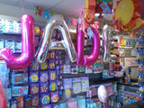 Pink and silver shaped letter foil balloons.