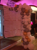 Organic demi balloon arch at party venue.