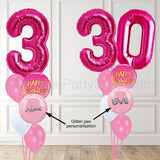 Large pink number shaped balloons with names printed on balloons