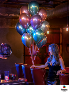 Girl holding bunch of shiny helium filled latex balloons.
