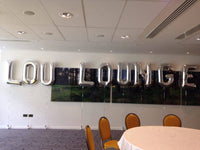 Large silver letter shaped balloons.