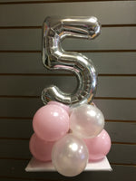 Silver number 5 balloon on top of pink and white balloons.