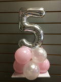 Silver number 5 balloon on top of pink and white balloons.