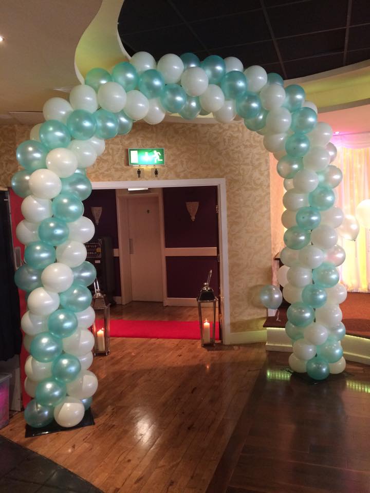 Teal and white coloured spiral balloon arch for a wedding reception.